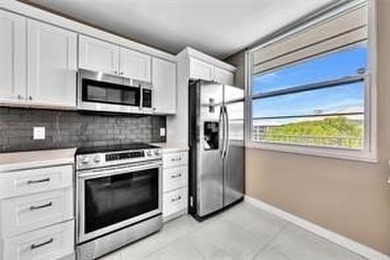 Lakefront Golf Course Condo. Move-in ready and beautifully on Pine Island Ridge Country Club in Florida - for sale on GolfHomes.com, golf home, golf lot