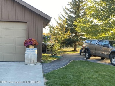 11 Last Chance Circle, a beautifully landscaped home in the on Cedar Creek Golf Course in Wyoming - for sale on GolfHomes.com, golf home, golf lot