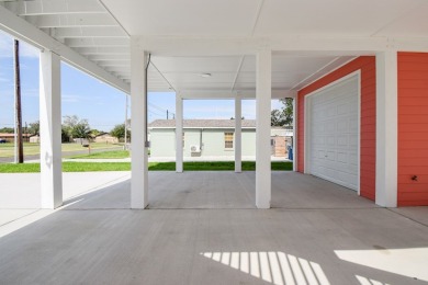 The home is elevated on pilings to allow for covered parking and on Rockport Country Club in Texas - for sale on GolfHomes.com, golf home, golf lot