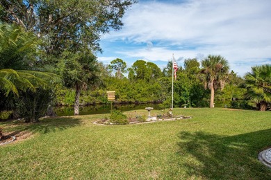 Situated in the desirable Gardens of Gulf Cove, this CANAL-FRONT on Duffys Golf Center in Florida - for sale on GolfHomes.com, golf home, golf lot
