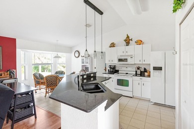 Situated in the desirable Gardens of Gulf Cove, this CANAL-FRONT on Duffys Golf Center in Florida - for sale on GolfHomes.com, golf home, golf lot