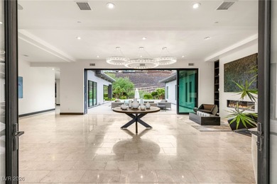 Tucked behind the gates of MacDonald Highlands, this exquisite on Dragon Ridge Country Club in Nevada - for sale on GolfHomes.com, golf home, golf lot