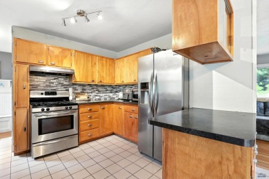 Welcome home to this spacious and full-of-character 5-bedroom on Meadowbrook Golf Course in South Dakota - for sale on GolfHomes.com, golf home, golf lot