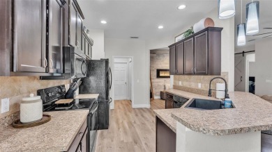 Welcome to 4565 Fairway Oaks Drive - a stunning 4-bedroom on Imperial Lakes Country Club in Florida - for sale on GolfHomes.com, golf home, golf lot