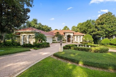 Tucked within the gates of Isleworth Golf Community and Country on Isleworth Golf and Country Club in Florida - for sale on GolfHomes.com, golf home, golf lot
