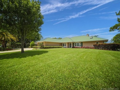 Nestled on a private acre w/majestic golf course views, this on Evergreen Club in Florida - for sale on GolfHomes.com, golf home, golf lot