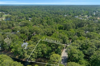 Nestled amidst stunning landscapes adorned with majestic trees on Long Cove Club in South Carolina - for sale on GolfHomes.com, golf home, golf lot