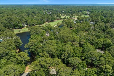 Nestled amidst stunning landscapes adorned with majestic trees on Long Cove Club in South Carolina - for sale on GolfHomes.com, golf home, golf lot