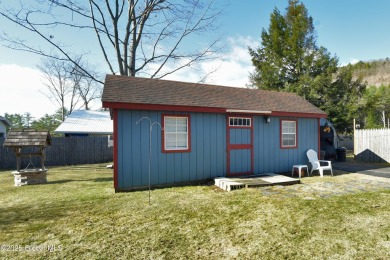 This charming cottage with approx 250 feet of direct water front on Bend Of The River Golf Course in New York - for sale on GolfHomes.com, golf home, golf lot
