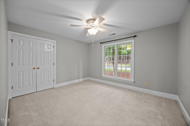 Nestled on a desirable corner lot, surrounded by mature trees in on Devils Ridge Golf Club in North Carolina - for sale on GolfHomes.com, golf home, golf lot