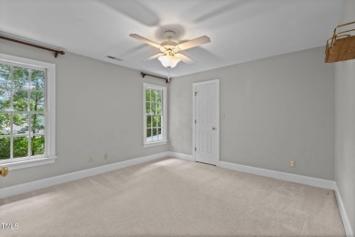 Nestled on a desirable corner lot, surrounded by mature trees in on Devils Ridge Golf Club in North Carolina - for sale on GolfHomes.com, golf home, golf lot