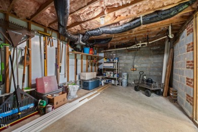 Nestled on a desirable corner lot, surrounded by mature trees in on Devils Ridge Golf Club in North Carolina - for sale on GolfHomes.com, golf home, golf lot