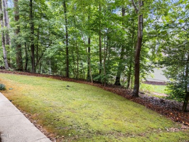 Nestled on a desirable corner lot, surrounded by mature trees in on Devils Ridge Golf Club in North Carolina - for sale on GolfHomes.com, golf home, golf lot