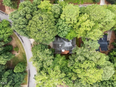 Nestled on a desirable corner lot, surrounded by mature trees in on Devils Ridge Golf Club in North Carolina - for sale on GolfHomes.com, golf home, golf lot