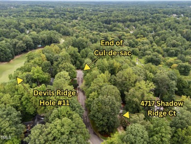 Nestled on a desirable corner lot, surrounded by mature trees in on Devils Ridge Golf Club in North Carolina - for sale on GolfHomes.com, golf home, golf lot