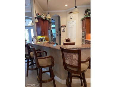 Step into the covered entry and elegant foyer, a formal dining on Estero Country Club in Florida - for sale on GolfHomes.com, golf home, golf lot