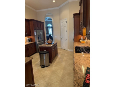 Step into the covered entry and elegant foyer, a formal dining on Estero Country Club in Florida - for sale on GolfHomes.com, golf home, golf lot