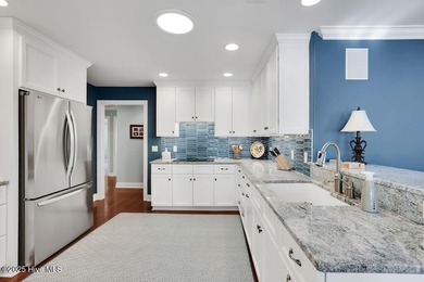 Serene nature views await you in this stunning brick home on Cape Fear National At Brunswick Forest in North Carolina - for sale on GolfHomes.com, golf home, golf lot