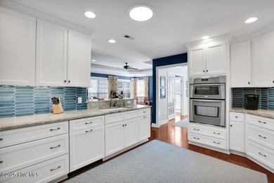 Serene nature views await you in this stunning brick home on Cape Fear National At Brunswick Forest in North Carolina - for sale on GolfHomes.com, golf home, golf lot