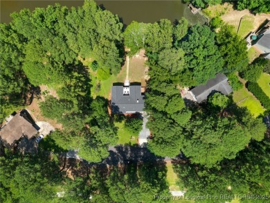 Incredible waterfront home located within the gated community of on Carolina Trace Country Club in North Carolina - for sale on GolfHomes.com, golf home, golf lot