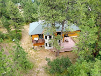 Nestled in the peaceful forest of Larkspur, CO, this mountain on The Golf Club At Bear Dance in Colorado - for sale on GolfHomes.com, golf home, golf lot