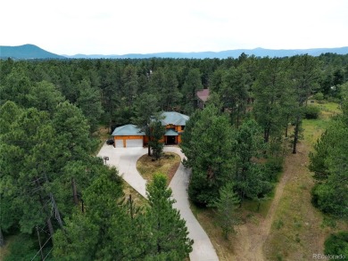 Nestled in the peaceful forest of Larkspur, CO, this mountain on The Golf Club At Bear Dance in Colorado - for sale on GolfHomes.com, golf home, golf lot