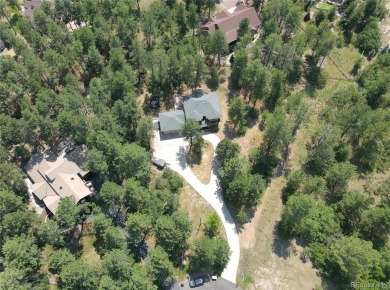 Nestled in the peaceful forest of Larkspur, CO, this mountain on The Golf Club At Bear Dance in Colorado - for sale on GolfHomes.com, golf home, golf lot