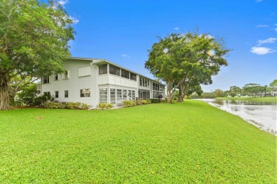 Discover exceptional lakeside living in this rare, rentable on Hillsboro Pines Golf in Florida - for sale on GolfHomes.com, golf home, golf lot