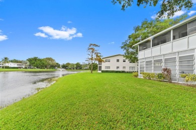 Discover exceptional lakeside living in this rare, rentable on Hillsboro Pines Golf in Florida - for sale on GolfHomes.com, golf home, golf lot