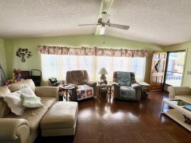 This charming two-bedroom, two-bathroom home is situated on a on Pine Lakes Country Club in Florida - for sale on GolfHomes.com, golf home, golf lot