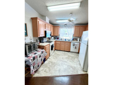 This charming two-bedroom, two-bathroom home is situated on a on Pine Lakes Country Club in Florida - for sale on GolfHomes.com, golf home, golf lot