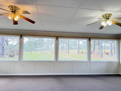 Enjoy the perfect sunset from the massive  picture windows on Pine Creek Golf Club in Mississippi - for sale on GolfHomes.com, golf home, golf lot