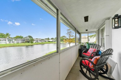 Discover exceptional lakeside living in this rare, rentable on Hillsboro Pines Golf in Florida - for sale on GolfHomes.com, golf home, golf lot