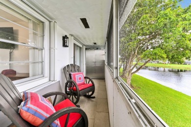 Discover exceptional lakeside living in this rare, rentable on Hillsboro Pines Golf in Florida - for sale on GolfHomes.com, golf home, golf lot