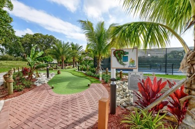 Discover exceptional lakeside living in this rare, rentable on Hillsboro Pines Golf in Florida - for sale on GolfHomes.com, golf home, golf lot