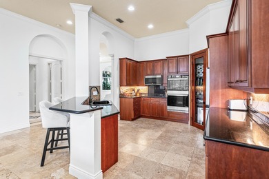 This former model home in Mizner Country Club has IMMEDIATE GOLF on Mizner Country Club in Florida - for sale on GolfHomes.com, golf home, golf lot