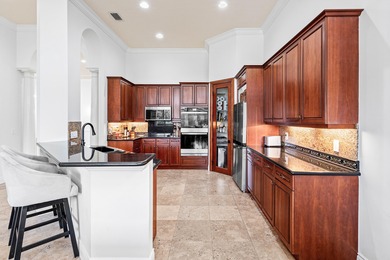 This former model home in Mizner Country Club has IMMEDIATE GOLF on Mizner Country Club in Florida - for sale on GolfHomes.com, golf home, golf lot