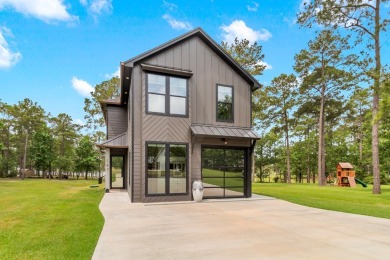 Experience unparalleled lakeside living at 147 Brushwood Ct on Rayburn Country Club in Texas - for sale on GolfHomes.com, golf home, golf lot