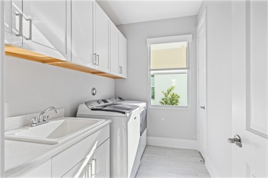 This sophisticated lakefront residence in The Falls at Grand on Oak Harbor Country Club in Florida - for sale on GolfHomes.com, golf home, golf lot