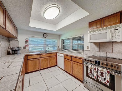 Nestled alongside the tranquil 14th hole of the golf course on Beacon Woods Golf Club in Florida - for sale on GolfHomes.com, golf home, golf lot