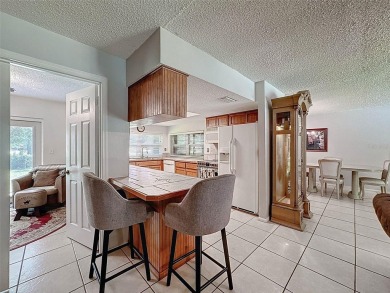 Nestled alongside the tranquil 14th hole of the golf course on Beacon Woods Golf Club in Florida - for sale on GolfHomes.com, golf home, golf lot