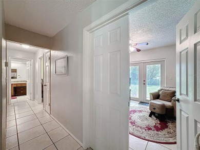 Nestled alongside the tranquil 14th hole of the golf course on Beacon Woods Golf Club in Florida - for sale on GolfHomes.com, golf home, golf lot