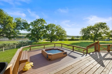 VIBRANT INKS LAKE COTTAGE -- Set on 1.2+ acres across two on Highland Lakes Golf Club in Texas - for sale on GolfHomes.com, golf home, golf lot