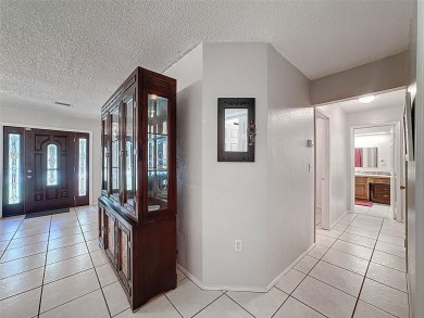 Nestled alongside the tranquil 14th hole of the golf course on Beacon Woods Golf Club in Florida - for sale on GolfHomes.com, golf home, golf lot
