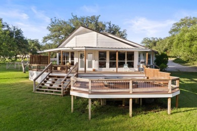 VIBRANT INKS LAKE COTTAGE -- Set on 1.2+ acres across two on Highland Lakes Golf Club in Texas - for sale on GolfHomes.com, golf home, golf lot
