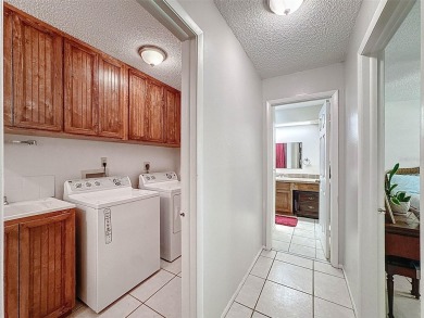 Nestled alongside the tranquil 14th hole of the golf course on Beacon Woods Golf Club in Florida - for sale on GolfHomes.com, golf home, golf lot