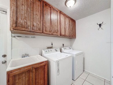 Nestled alongside the tranquil 14th hole of the golf course on Beacon Woods Golf Club in Florida - for sale on GolfHomes.com, golf home, golf lot