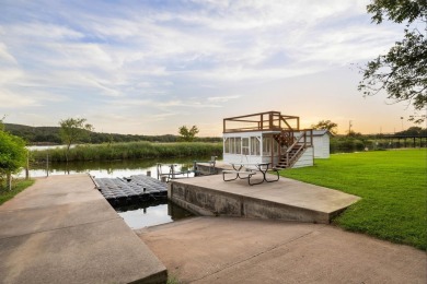VIBRANT INKS LAKE COTTAGE -- Set on 1.2+ acres across two on Highland Lakes Golf Club in Texas - for sale on GolfHomes.com, golf home, golf lot