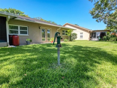 Nestled alongside the tranquil 14th hole of the golf course on Beacon Woods Golf Club in Florida - for sale on GolfHomes.com, golf home, golf lot
