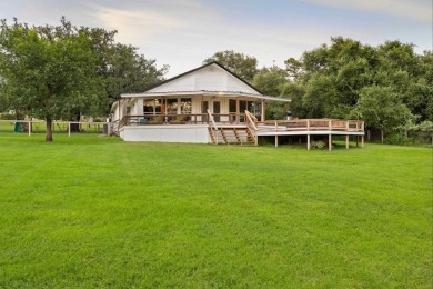 VIBRANT INKS LAKE COTTAGE -- Set on 1.2+ acres across two on Highland Lakes Golf Club in Texas - for sale on GolfHomes.com, golf home, golf lot